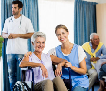 elder woman and nurse smiling